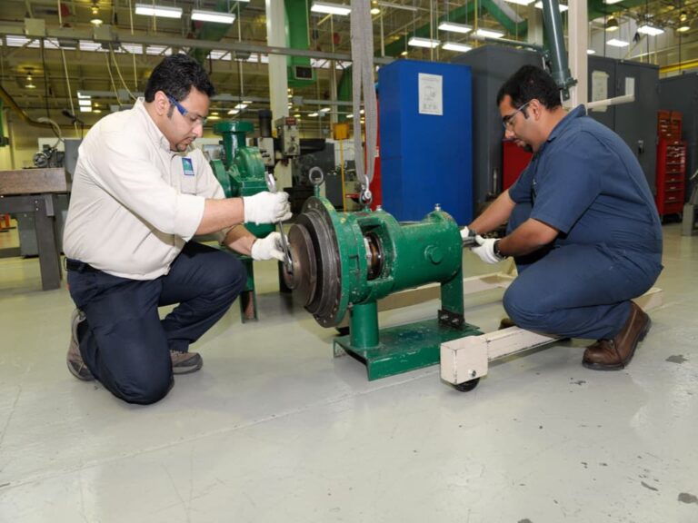 Two engineers working on a test pump.