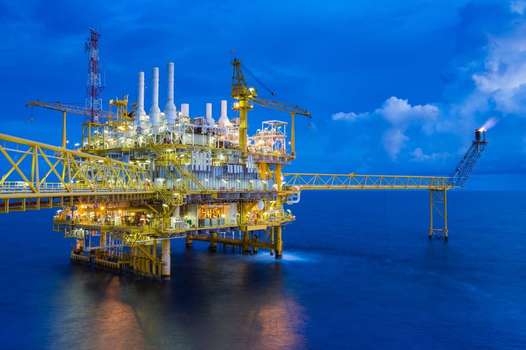 Yellow oil rig in the ocean.